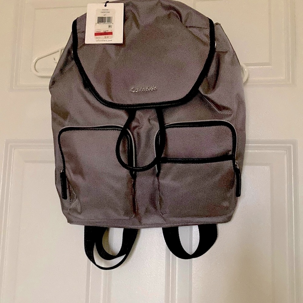 Calvin Klein grey backpack 14 x 16 inches, two pouches at front, one inside